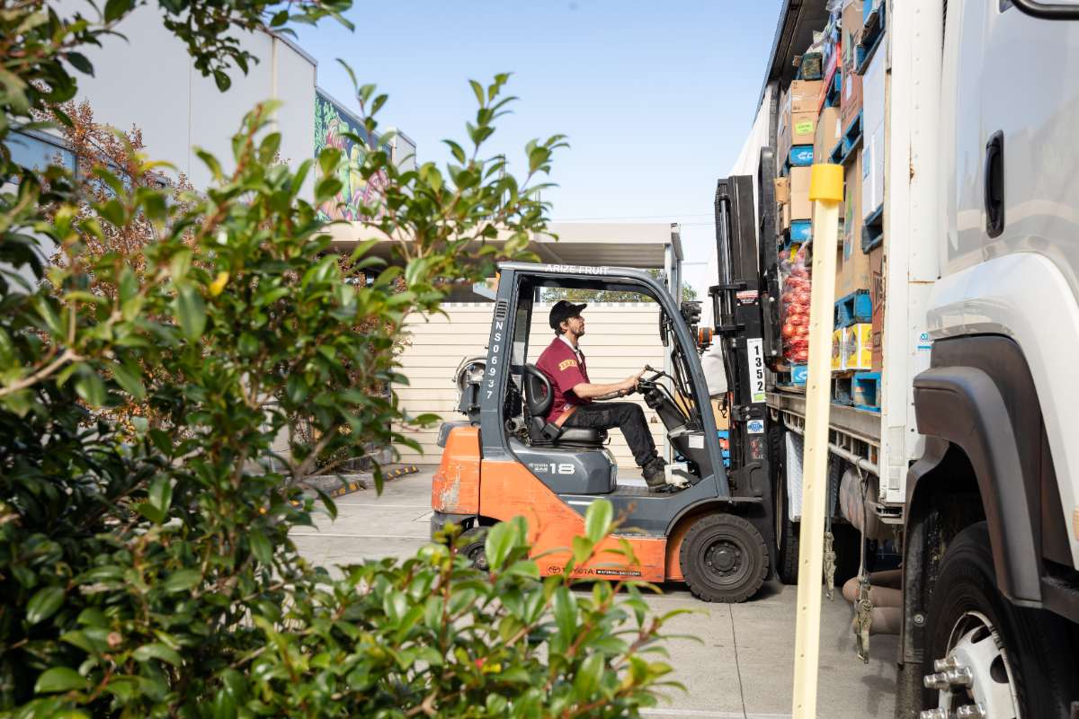 A Nowra Fresh Market Employee pulling fresh produce of the delivery truck using a forklift